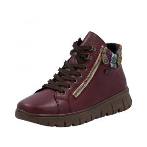 Baskets femme Cuir souple Imperméable Semelle épaisse Chaussant large Empiècement multicolore RIEKER N1305-35 coloris bordeaux. Vue de biais d'une chaussure gauche.