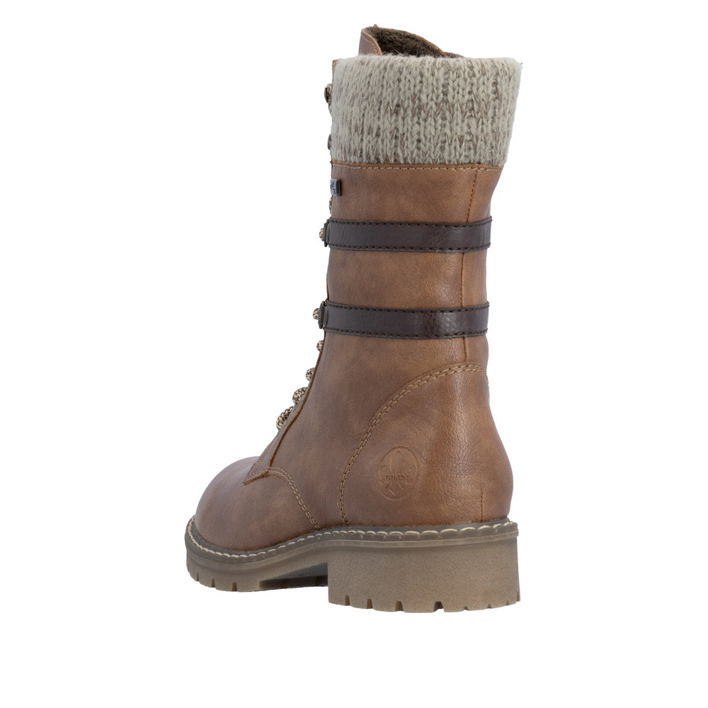 Boots femme Doublure chaude Lacets + zip Bottine dame faux cuir Talon décroché RIEKER Coloris marron camel. Vue de biais de l'arrière d'une chaussure gauche laissant apparaître la hauteur du talon.